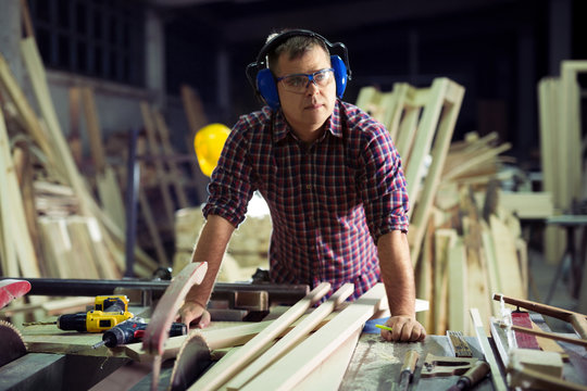Carpenter doing his job in carpentry workshop © zorandim75