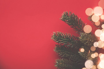 Christmas background with fir tree branches and bokeh blurred fairy lights