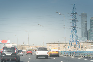 high speed road cars in the background of high voltage towers