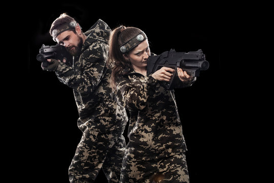 Heavily armed masked soldiers isolated on black background. Paint ball and laser tag sport games.