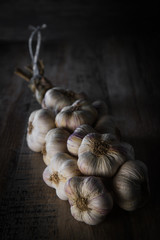 Garlic Cloves and Garlic Bulb on vintage wood background