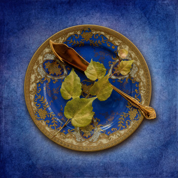 Place setting, plate with leaves and fish knife