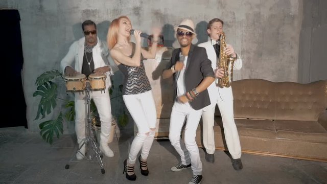 Four musicians perform in a nightclub. slow motion