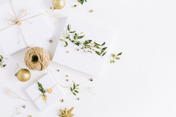 White handmade Christmas gift boxes. Flat lay, top view holiday composition.