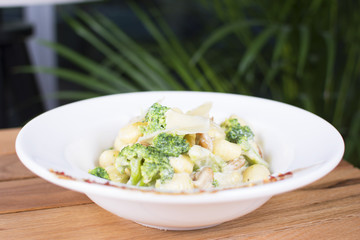 Nice stuffed meat with tomatoes with gnocchi. White cream topping with the touch of green seasoning. Beautifully served plate at the restaurant.