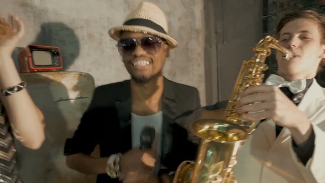 Four professional musicians dance and sing. close-up