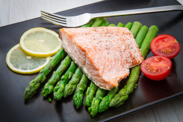 salmon fillet on asparagus bed on dish