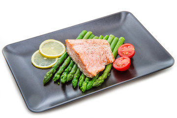 salmon fillet on asparagus bed on dish