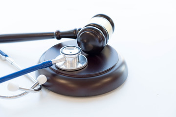 Gavel and stethoscope. medical jurisprudence. legal definition of medical malpractice. attorney. common errors doctors, nurses and hospitals make