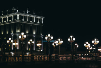 Fototapeta na wymiar Skopje, Macedonia, Art Bridge at Night. European city architecture, famous bridge with sculptures.