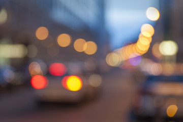 Out of focus lights of traffic on a street in the evening