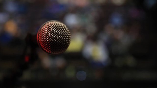 POV of a performer walking up to microphone on stage before a live audience