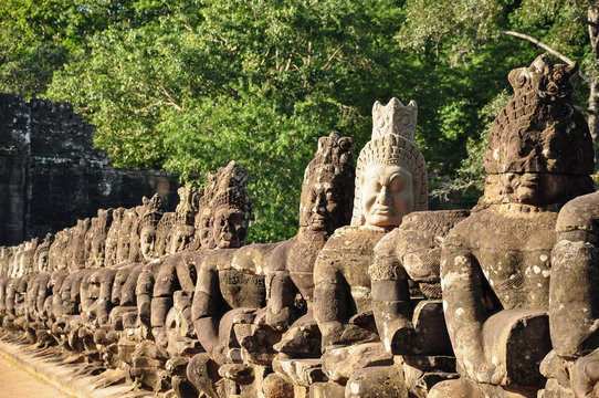 Row of sculptures in the South Gate of Angkor Thom