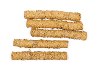 Integral bread sticks with sunflower seeds isolated on white background, top view