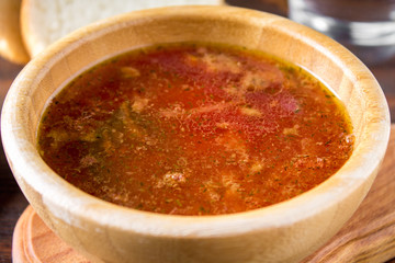 Traditional Ukrainian Russian vegetable borscht on the old wooden background.