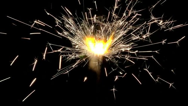 Sparkler enchanting lights. Lights sparked and burned in his hands. Festive sparklers close - an attribute of good mood.