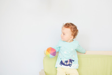 little child is playing with toys in the studio