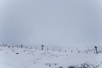 Empty cable cars for skiers in the snow-capped mountains in anticipation of the opening of the season.