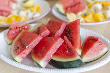 Plate of freshly cut juicy watermelon pieces ready for breakfast
