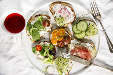 Breakfast in bed different fresh sandwiches. Top view shot, health care concept.