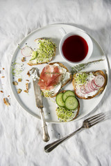 Breakfast in bed different fresh sandwiches. Top view shot, health care concept.