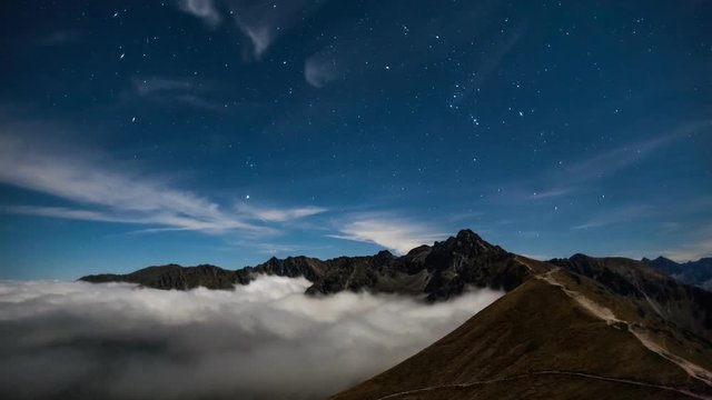 Orion constellation rising over the mountains
