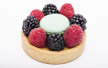 Fresh berry cake on a white background.