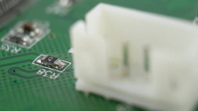 Electonic components on green circuit board. Integrated semiconductor microchip. System board with microchips and transistors