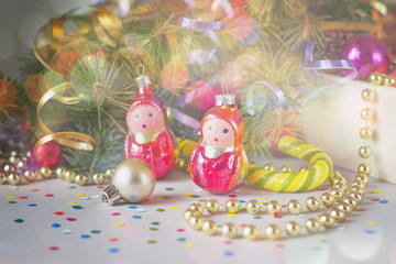 Christmas toys on the background of fir-tree branches, vintage style.