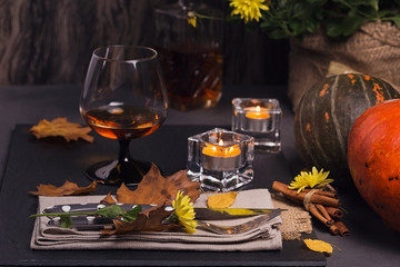 Table setting with autumn decoration for Thanksgiving.