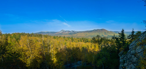 Fototapeta na wymiar Panorama of early autumn from the height of Taganay mountain of the Ural range