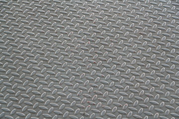 Metal floor plate with diamond pattern.