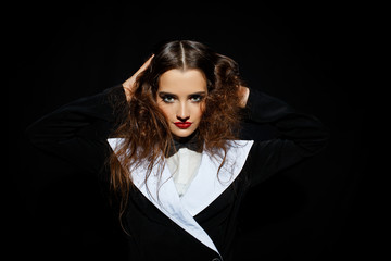 Model in black stylish suit with red lipstick
