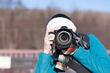 Young girl takes pictures of nature.