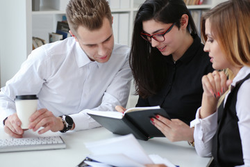 Group of people sit in office deliberate on problem