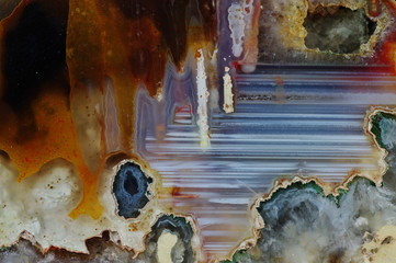 Macrophotography of cut agate. Stalactite-horizontal agate. Multicolored silica bands colored with metal oxides are visible. Origin: Rudno near Krakow, Poland.