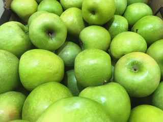 Green apple background in supermarket