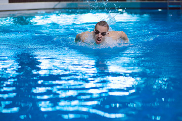 Male swimmer at the swimming pool. Underwater photo. Male swimmer.