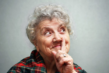 Elderly smile woman with hand and finger up
