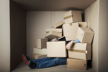teenager student in small office littered with boxes, concept - too much work