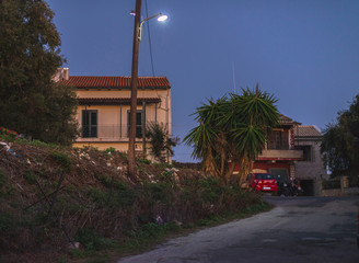Vintage street lantern at dusk in small mountain village. Corfu, Greece.