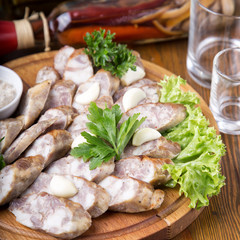 Meat snack from homemade sausage on a wooden board