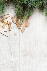 Christmas background. Christmas decorations lie on old boards. Fir branches. Handmade decorations. Light boards.