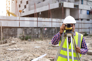 Asian civil engineer checking work for control and management in the construction site or building site