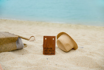 Straw hat, bag , and towels for swimming on a tropical beach