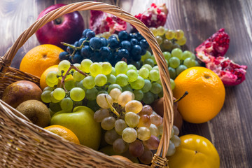 Composition with assorted fruits in wicker basket, healthy life