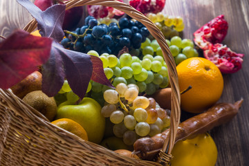 Composition with assorted fruits in wicker basket, healthy life