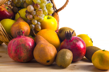 Composition with assorted fruits in wicker basket, healthy life