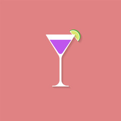 A cocktail and a slice of lime. A glass of Martini