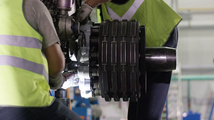 Calm workers controlling aircraft machine and chassis. Aircraft maintenance mechanic inspects plane...